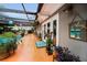 Relaxing pool area with covered patio, plants, and unique decor, offering a tranquil outdoor living space at 1151 Lancer Ln, Tarpon Springs, FL 34689