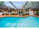 Screened pool area with ample patio space and colorful lanterns creating a relaxing atmosphere at 1151 Lancer Ln, Tarpon Springs, FL 34689