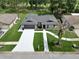 An aerial view shows a single-story home with a well-manicured lawn, complemented by a long driveway at 12807 Starling Dr, Odessa, FL 33556