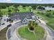 An aerial view showcases the Eagles Golf Club clubhouse, with its circular drive, golf carts, and lush landscaping at 12807 Starling Dr, Odessa, FL 33556