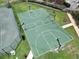 Aerial view of a well-maintained basketball court with vibrant green surface, inviting community members for recreation at 12807 Starling Dr, Odessa, FL 33556