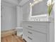 Bathroom featuring a walk-in shower, marble countertop, and wooden-style floors at 12807 Starling Dr, Odessa, FL 33556