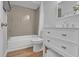 Bathroom featuring a bathtub, granite countertop, and wood-style floors at 12807 Starling Dr, Odessa, FL 33556