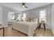 Bright bedroom features a ceiling fan, hardwood floors, and a mirrored closet at 12807 Starling Dr, Odessa, FL 33556
