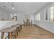 Charming dining area with pendant lighting, wood floors, and ample natural light from the window at 12807 Starling Dr, Odessa, FL 33556