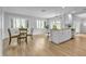 Bright dining area featuring white cabinets and trim, wood floors, and stylish pendant lighting at 12807 Starling Dr, Odessa, FL 33556