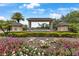 Welcoming entrance to The Eagles Golf Club & Gated Community, adorned with vibrant flowerbeds and lush landscaping at 12807 Starling Dr, Odessa, FL 33556
