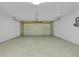 Empty garage featuring an automatic garage door and white walls at 12807 Starling Dr, Odessa, FL 33556