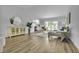Bright living room with wood floors, neutral paint, and natural light, next to the open kitchen at 12807 Starling Dr, Odessa, FL 33556