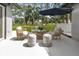 Covered patio area with outdoor seating, umbrella, and a beautiful outdoor view at 12807 Starling Dr, Odessa, FL 33556