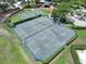 Overhead shot of community tennis courts, with net lines, and fenced perimeter providing an active lifestyle at 12807 Starling Dr, Odessa, FL 33556