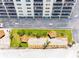 Aerial view of building with outdoor amenities including a parking lot and a bocce ball court near the beach at 13500 Gulf Blvd # 507, Madeira Beach, FL 33708