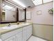 Bathroom with dual sinks and white cabinets at 13500 Gulf Blvd # 507, Madeira Beach, FL 33708