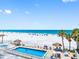 Relaxing pool and beach scene with lounge chairs offering an ideal seaside vacation spot at 13500 Gulf Blvd # 507, Madeira Beach, FL 33708