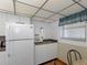 Kitchen corner features ample storage, updated appliances, and laminate wood flooring at 13500 Gulf Blvd # 507, Madeira Beach, FL 33708