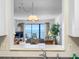 View from kitchen to living room with ocean view at 13500 Gulf Blvd # 507, Madeira Beach, FL 33708