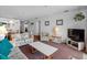 Open-concept living room with comfortable seating, TV, and a view to the dining area at 13500 Gulf Blvd # 507, Madeira Beach, FL 33708