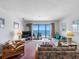 Cozy living area featuring a balcony with ocean views for a serene living experience at 13500 Gulf Blvd # 507, Madeira Beach, FL 33708