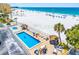 Beachside pool and lounge area with palm trees offering a perfect vacation getaway at 13500 Gulf Blvd # 507, Madeira Beach, FL 33708