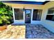 Rear of house featuring a cozy back entrance with tiled patio and freshly painted exterior at 1373 Fairfax Rd, Clearwater, FL 33764