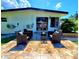 Outdoor patio with wicker seating, tile flooring, and sliding glass doors for easy indoor-outdoor living at 1373 Fairfax Rd, Clearwater, FL 33764