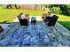Inviting back patio with wicker furniture on patterned tiles, perfect for outdoor entertaining at 1373 Fairfax Rd, Clearwater, FL 33764