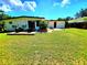Spacious backyard featuring a patio with outdoor seating and a well-maintained lawn at 1373 Fairfax Rd, Clearwater, FL 33764