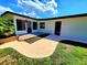 Exterior view of the house featuring a well-maintained lawn, patio, and multiple entry points at 1373 Fairfax Rd, Clearwater, FL 33764