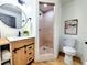 Modern bathroom featuring updated vanity, lighting, stand up shower, updated flooring, and updated toilet at 1373 Fairfax Rd, Clearwater, FL 33764
