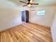 Spacious bedroom featuring updated flooring, ceiling fan, and updated lighting with mini-split at 1373 Fairfax Rd, Clearwater, FL 33764