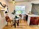 Bright dining area with natural light, wood flooring, and table with chairs next to kitchen island at 1373 Fairfax Rd, Clearwater, FL 33764