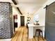 Bright dining area with light wood flooring, modern decor, and open layout featuring sliding barn door at 1373 Fairfax Rd, Clearwater, FL 33764