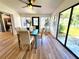 Bright dining room with light wood flooring, dining table, and sliding glass doors offering natural light at 1373 Fairfax Rd, Clearwater, FL 33764