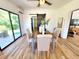 Bright dining room featuring light wood flooring, dining table, and sliding barn door access to another room at 1373 Fairfax Rd, Clearwater, FL 33764
