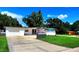 Charming one-story home featuring modern paint, green grass, and a spacious driveway at 1373 Fairfax Rd, Clearwater, FL 33764