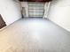 Clean garage featuring a newly finished floor with a modern epoxy coating and ample space at 1373 Fairfax Rd, Clearwater, FL 33764