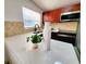 Bright kitchen featuring a white quartz countertop, stainless steel sink, and modern appliances at 1373 Fairfax Rd, Clearwater, FL 33764