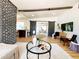 Stylish living room with open floor plan, decorative brick, and sliding barn doors at 1373 Fairfax Rd, Clearwater, FL 33764