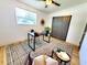 Well-lit office with a ceiling fan, a window, contemporary décor, and a dark closet door at 1373 Fairfax Rd, Clearwater, FL 33764