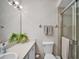 Bright bathroom featuring a glass door shower, neutral-toned walls, and decorative plants on the vanity at 1400 Tarpon Woods Blvd # A4, Palm Harbor, FL 34685