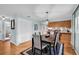 Dining area with modern lighting fixture and view into kitchen at 1400 Tarpon Woods Blvd # A4, Palm Harbor, FL 34685