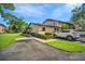 Charming home exterior with well-maintained landscaping, a paved driveway, and a modern car parked at 1400 Tarpon Woods Blvd # A4, Palm Harbor, FL 34685