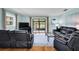 Spacious living room featuring hardwood floors and sliding glass doors to patio at 1400 Tarpon Woods Blvd # A4, Palm Harbor, FL 34685