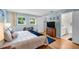 A well-lit main bedroom with hardwood floors, two windows, and a private bathroom at 1400 Tarpon Woods Blvd # A4, Palm Harbor, FL 34685
