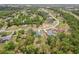 Aerial view of home nestled among mature trees in a suburban neighborhood at 14494 Copeland Way, Brooksville, FL 34604