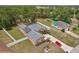Aerial view of a single-Gathering home with a gray roof, solar panels, and a long driveway at 14494 Copeland Way, Brooksville, FL 34604