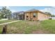 Expansive backyard featuring a screened-in lanai, and lush green grass, perfect for outdoor enjoyment at 14494 Copeland Way, Brooksville, FL 34604