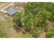 Aerial view of backyard with enclosed pool, fenced area, and trees at 14494 Copeland Way, Brooksville, FL 34604