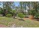Large backyard with mature trees and an outdoor shed at 14494 Copeland Way, Brooksville, FL 34604