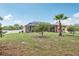 Expansive backyard with mature trees, screen-enclosed lanai and white vinyl fencing at 14494 Copeland Way, Brooksville, FL 34604